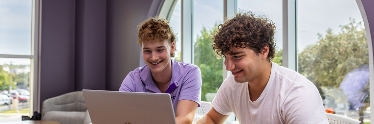 Students using a laptop computer to apply to TCU