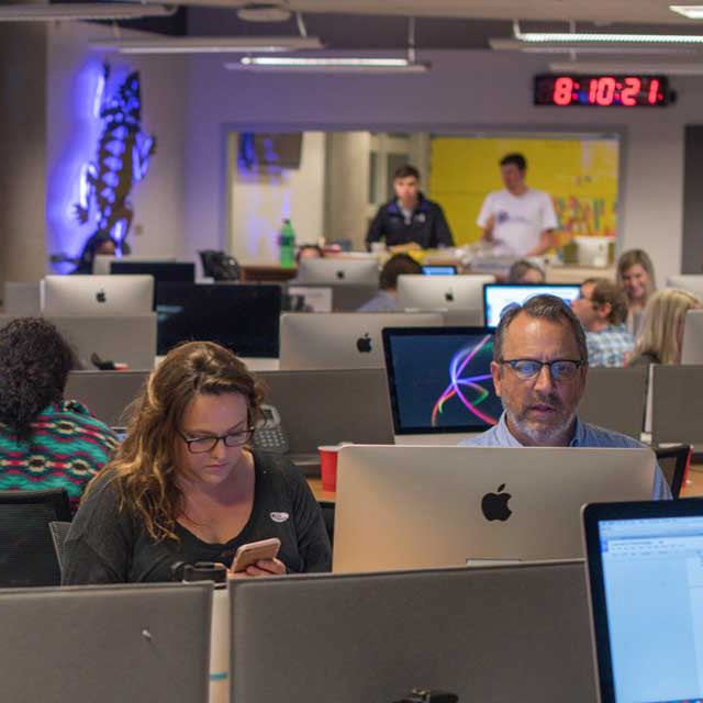 Students work alongside faculty in the press room