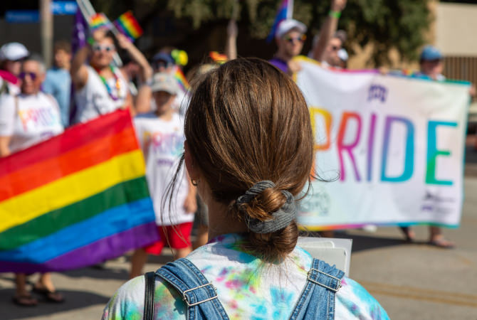 girl watching a gay pride parade