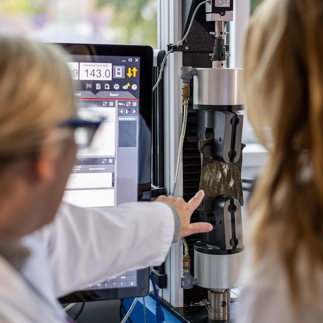 TCU Textile researchers looking at fabric in a lab setting