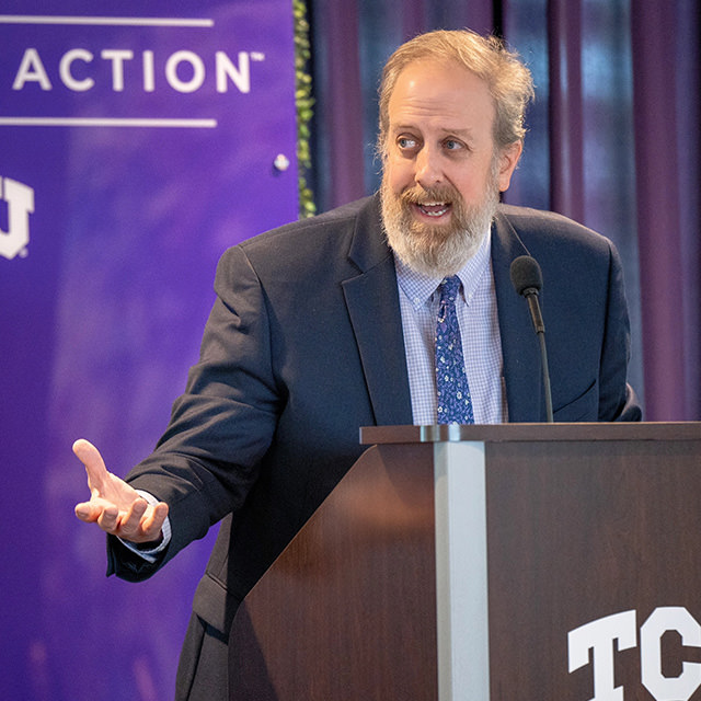 Tom Wavering speaking from a TCU lecturn